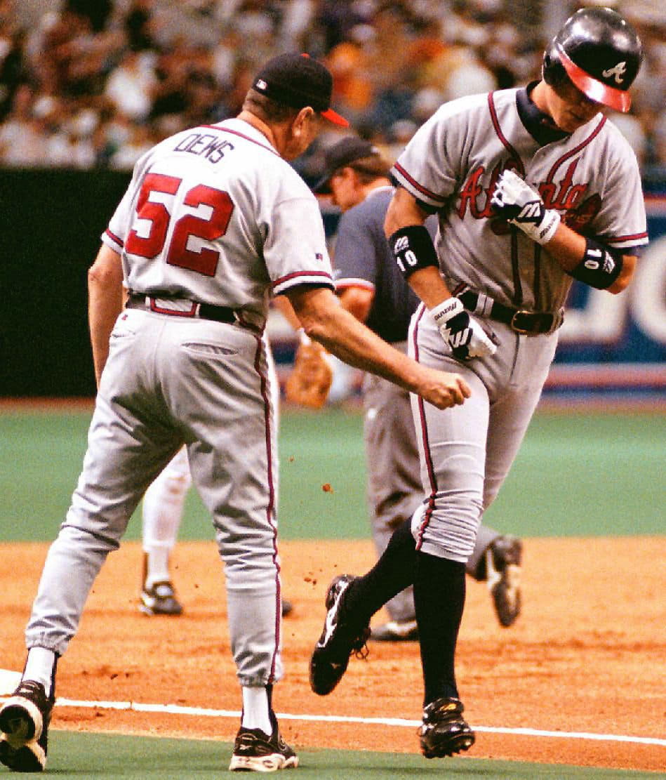 Atlanta Braves’ Chipper Jones (R) is greeted by co