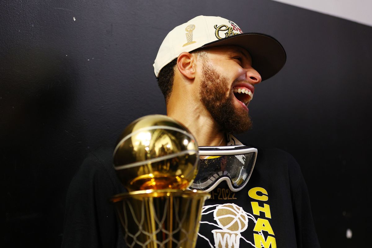 Stephen Curry #30 of the Golden State Warriors celebrates with the Bill Russell NBA Finals Most Valuable Player Award