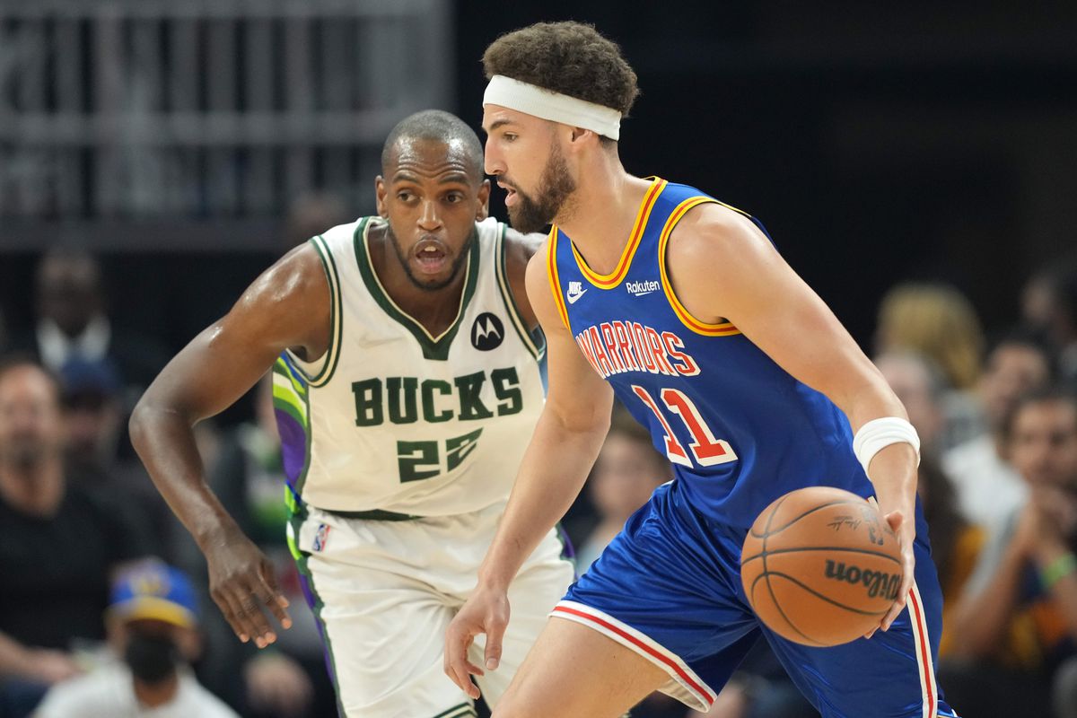 San Francisco, California, USA; Golden State Warriors guard Klay Thompson (11) dribbles against Milwaukee Bucks forward Khris Middleton (22) during the first quarter at Chase Center.