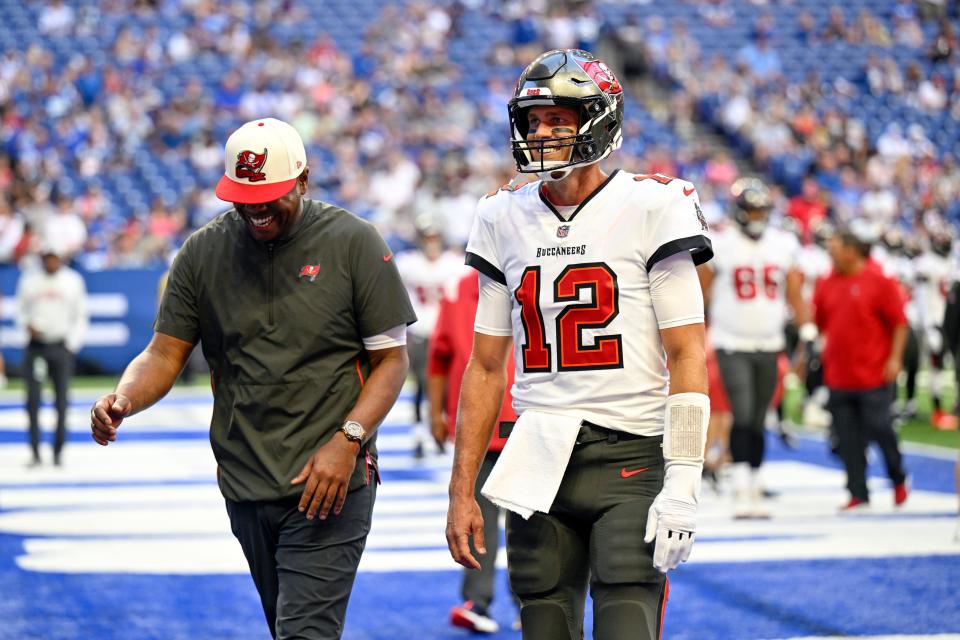 Tampa Bay Buccaneers quarterback Tom Brady (12) smiles while he walks off the field  before the game against the Indianapolis Colts at Lucas Oil Stadium.